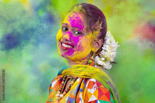 Photography Portrait of  young Indian Woman celebrating Holi color festival