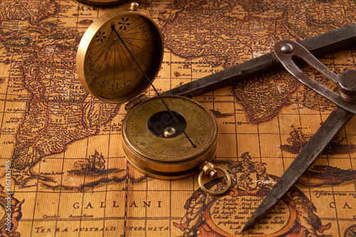 Old vintage retro compass on ancient world map. Vintage still life. Travel geography navigation concept background.