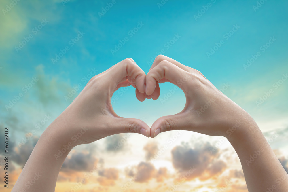 Human hands Heart shaped the sky in the background blurred.Environment Day concept. The power harmonious Human hands Heart shaped the sky in the background blurred.Environment Day concept. The power harmonious