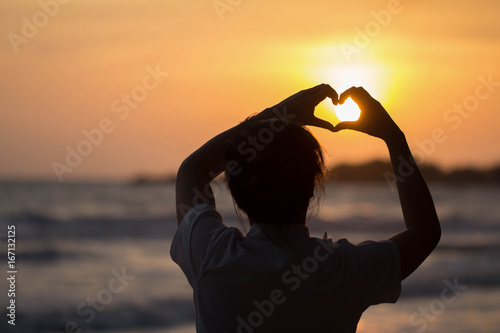 beautiful woman Heart-shaped handmade During sunset style Silhouette