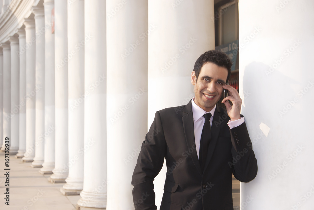 Portrait of a businessman talking on a mobile phone , INDIA , DELHI Portrait of a businessman talking on a mobile phone , INDIA , DELHI