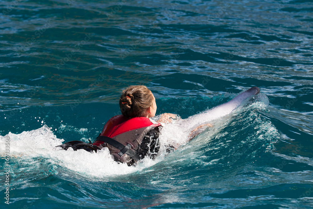 Girl and dolphin swim together Girl and dolphin swim together