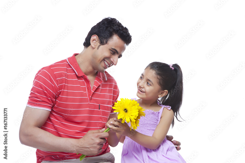 Happy father giving sunflowers to daughter over white background Happy father giving sunflowers to daughter over white background