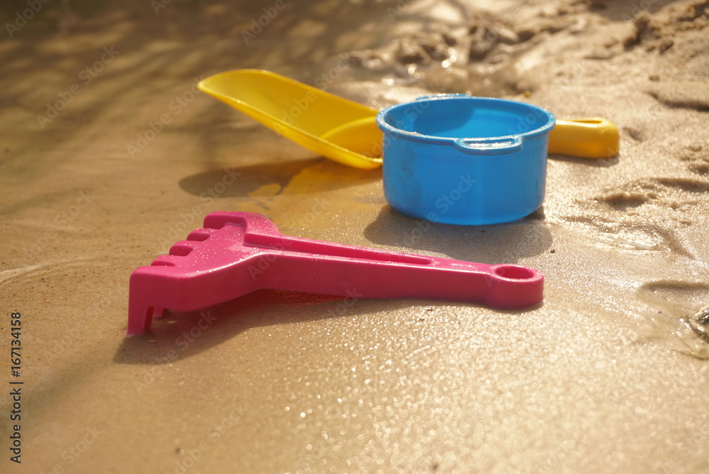 Children's toys on the beach of the lake Children's toys on the beach of the lake