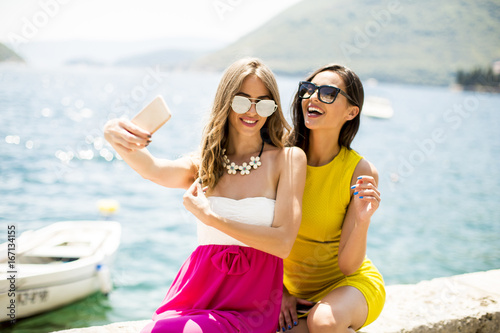 Two pretty young women taki...