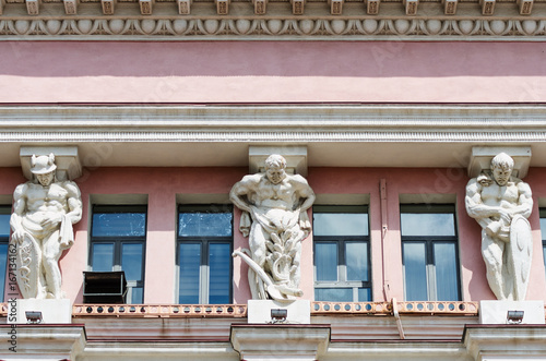 Atlanties supporting the cornice of the building / Photo taken in Russia, in the city of Orenburg