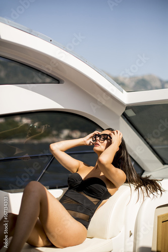 Pretty young woman relaxing on the yacht © BGStock72