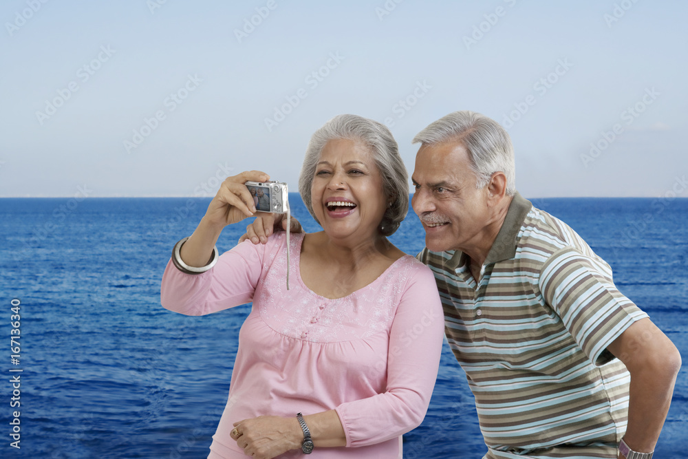 Couple looking at photographs in a camera 