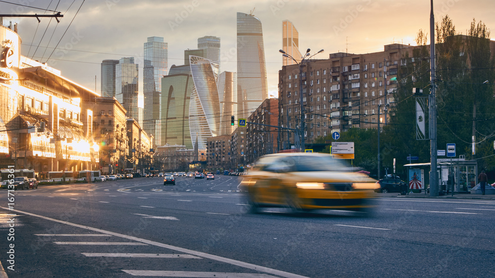 Cityscape at sunset with the city traffic and skyscrapers at background