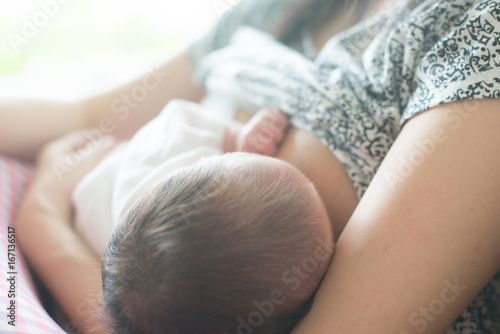 Mother breast feeding and hugging her baby. photo