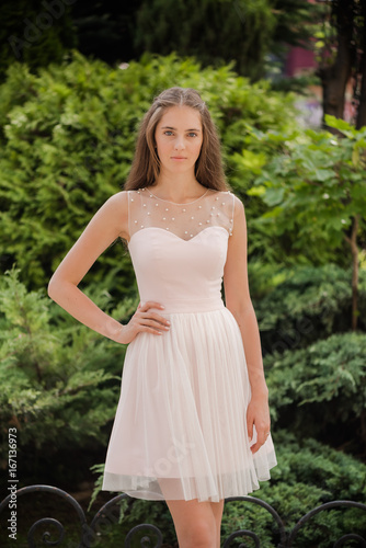 Young beautiful woman in a light summer dress