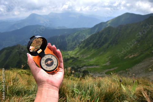Compass in the mountains, travel path tourism, summer
