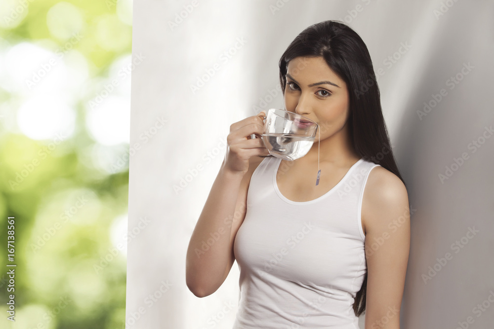 Portrait of pretty young woman having a cup of herbal tea Portrait of pretty young woman having a cup of herbal tea