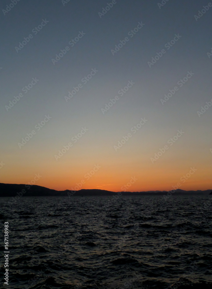 Orange color sunset afterglow on deep blue sky over the North Sea in Bergen, Norway