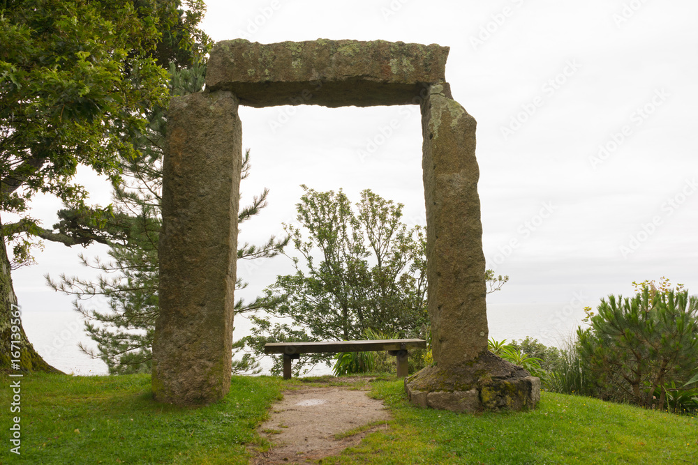 Large slabs of stone creating a doorway in a park in Cornwall by the coast in the summertime at daytime