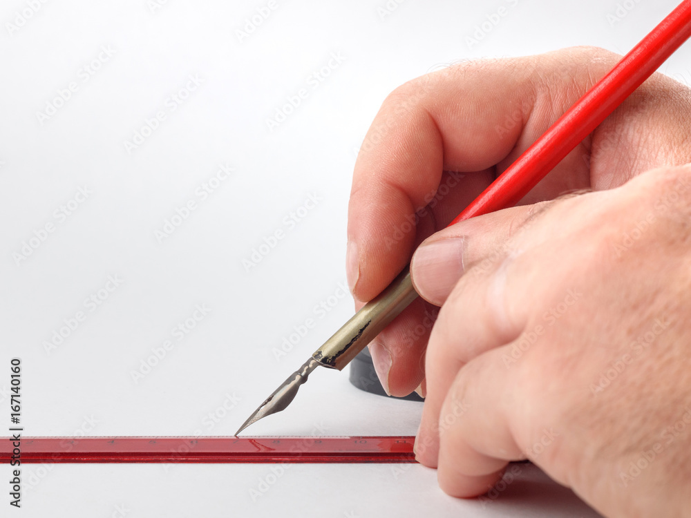 hand holding old inkpen on white paper background hand holding old inkpen on white paper background