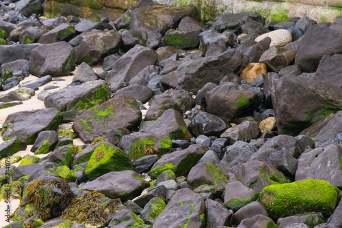 Large rocks on a beach in Cornwall in the summertime, around mid day.