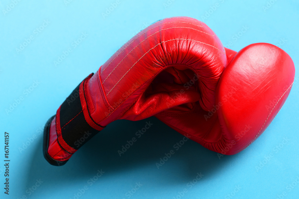 Boxing gloves in red color. Sport equipment on blue