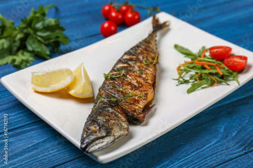 Fototapeta Naklejka Na Ścianę i Meble -  Grilled tasty fish on white plate with vegetables