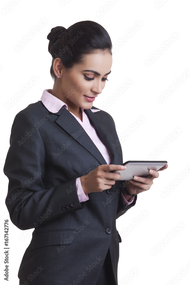 Young Indian businesswoman using digital tablet over white background Young Indian businesswoman using digital tablet over white background