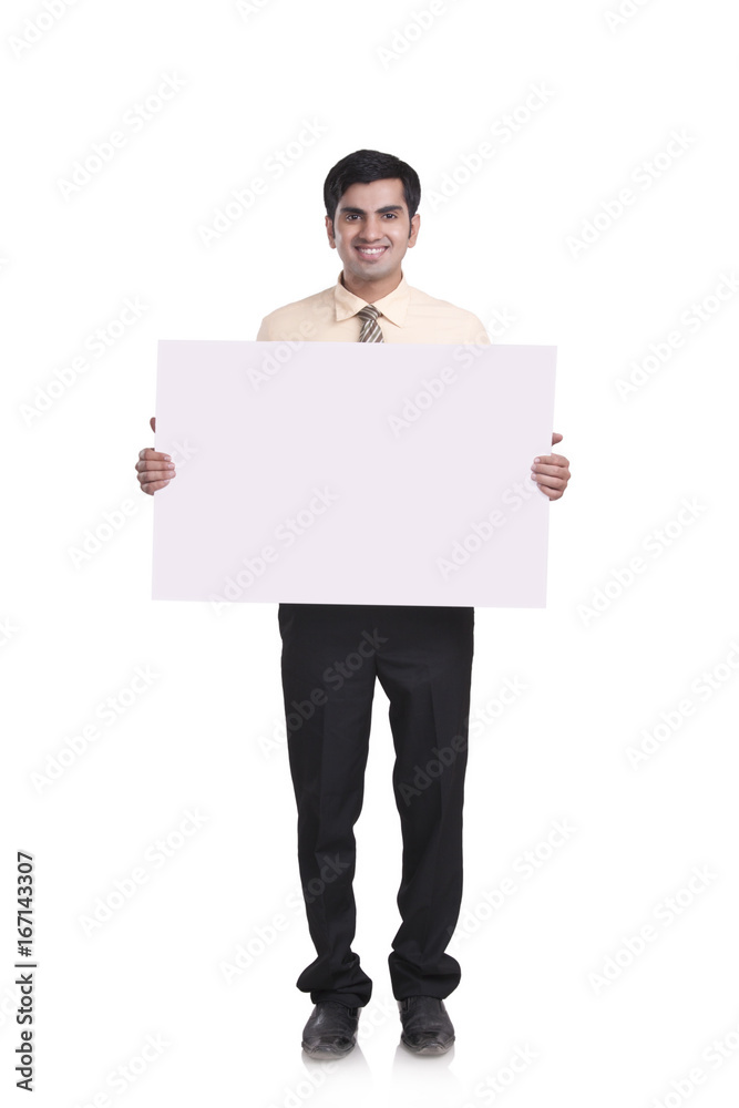 Full length portrait of confident businessman holding blank placard over white background Full length portrait of confident businessman holding blank placard over white background