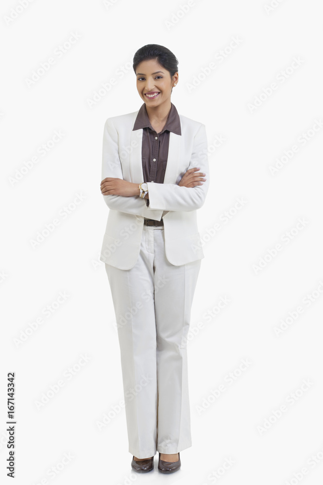 Full length portrait of happy businesswoman with arms crossed isolated over white background 