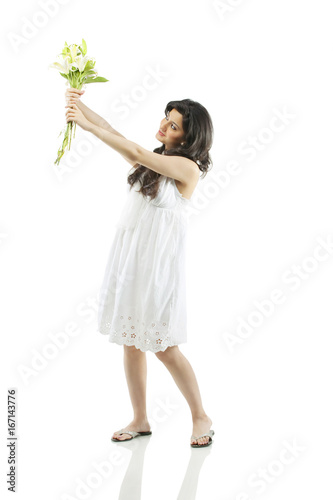 A beautiful woman holding flowers 