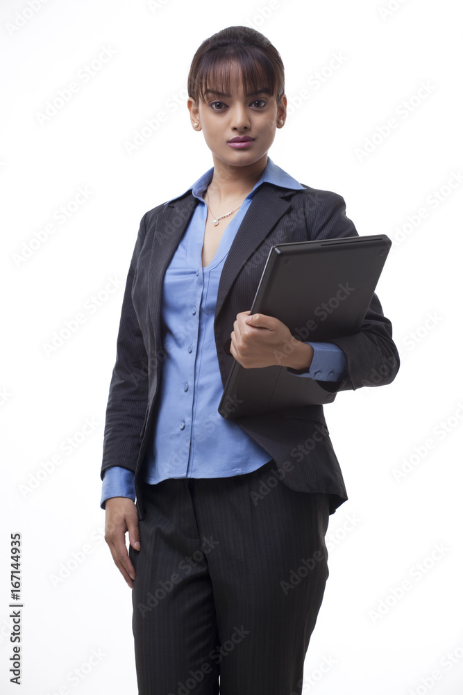 Portrait of confident young businesswoman holding laptop over white background Portrait of confident young businesswoman holding laptop over white background