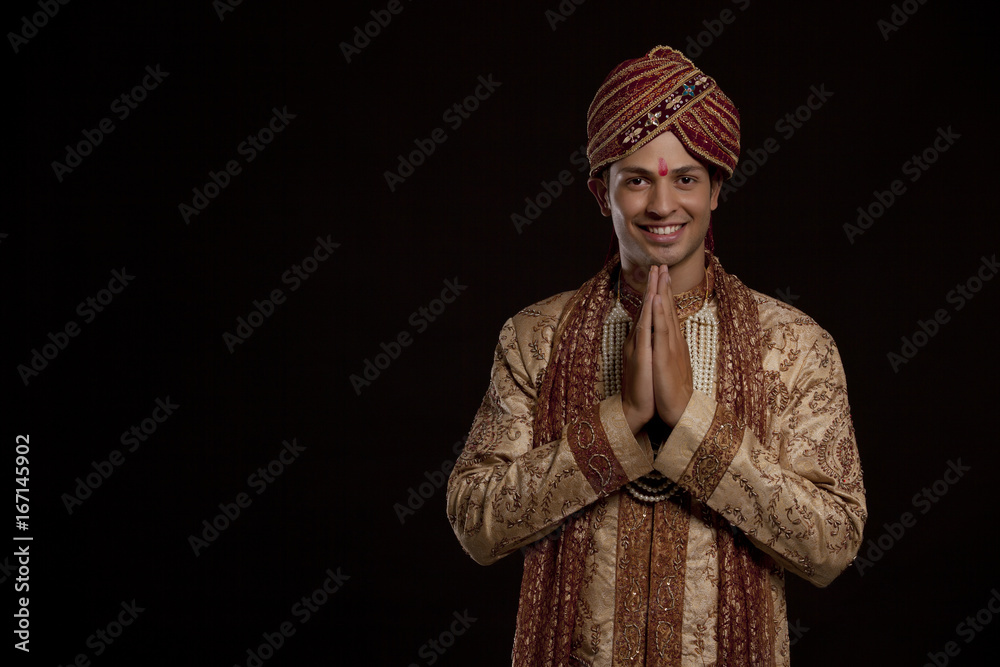 Portrait of a Gujarati groom greeting 