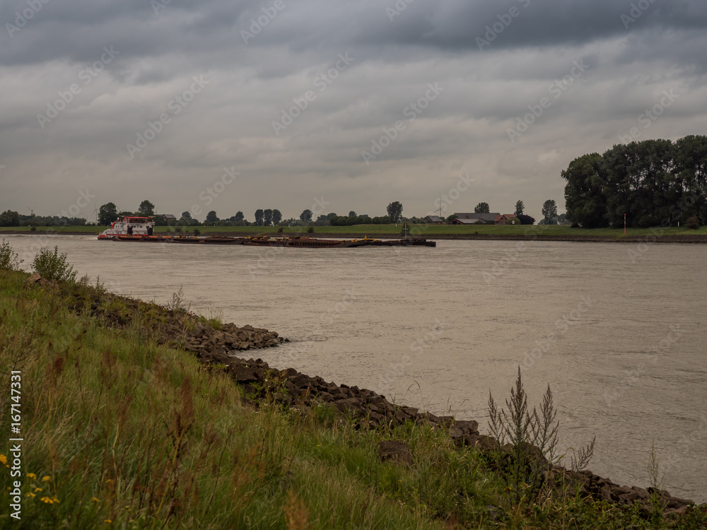 big pushing ship drives upstream the rhine, Grieth am Rhein, Germany big pushing ship drives upstream the rhine, Grieth am Rhein, Germany