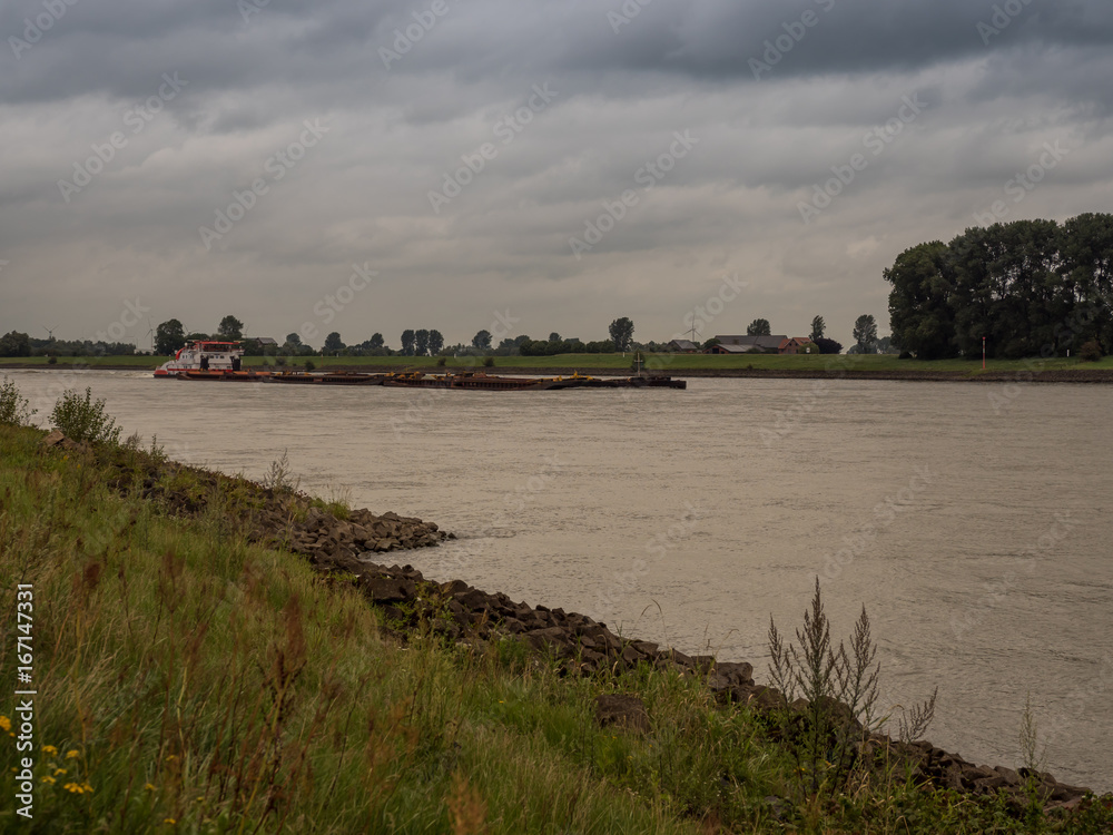 big pushing ship drives upstream the rhine, Grieth am Rhein, Germany