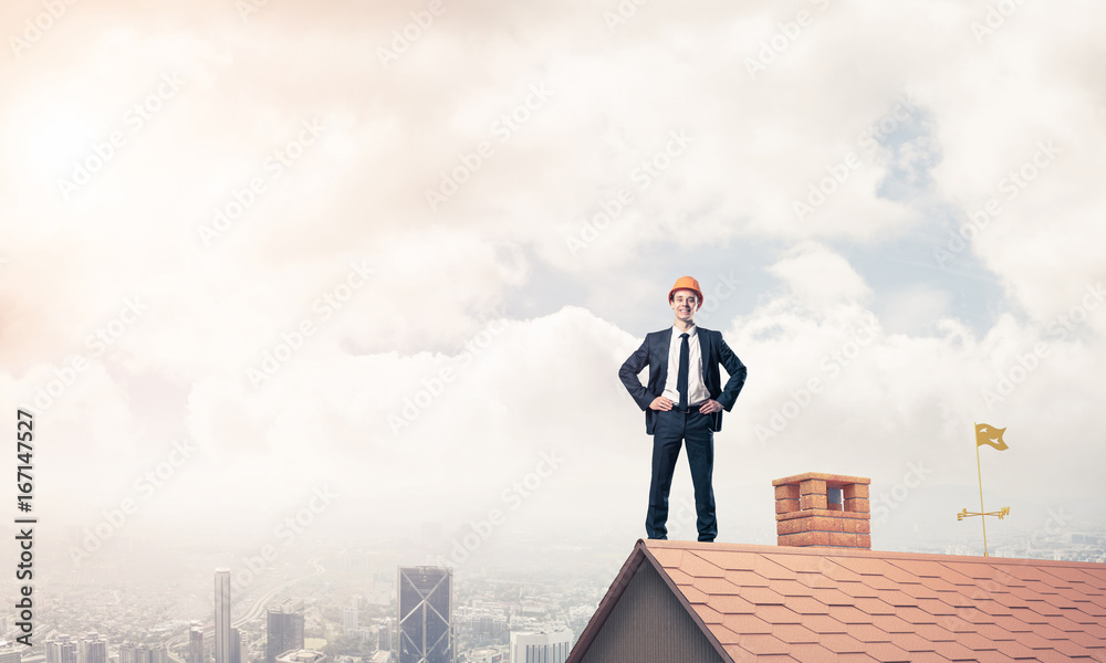 Engineer man standing on roof and looking away. Mixed media Engineer man standing on roof and looking away. Mixed media