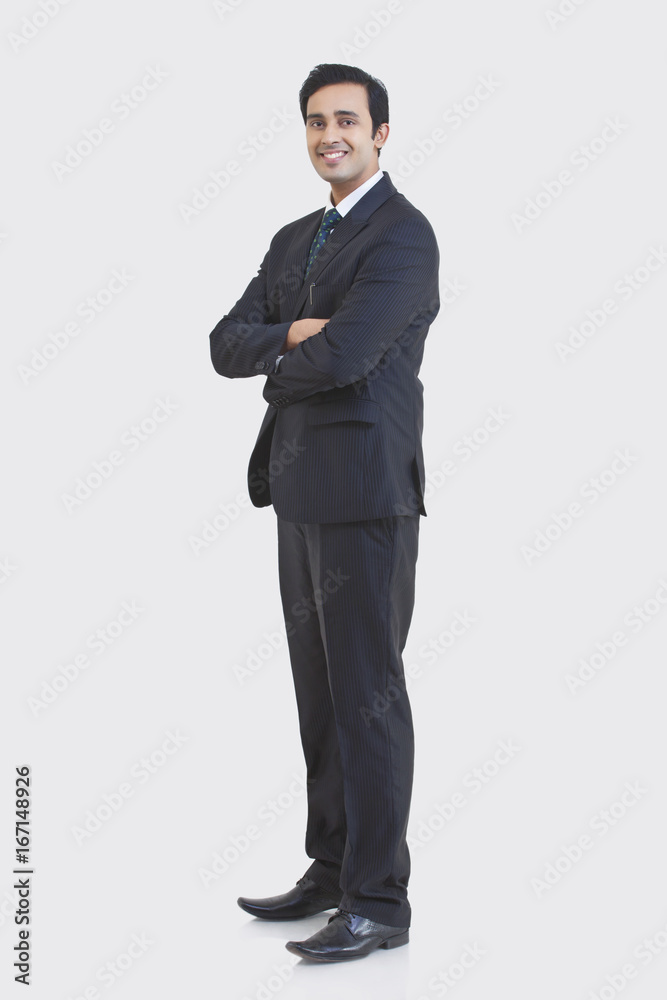 Full length portrait of young businessman in suit isolated over gray background Full length portrait of young businessman in suit isolated over gray background
