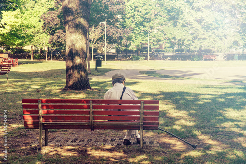 lonely senior sitting on a bench