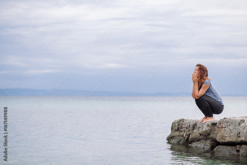 Woman alone and depressed at seaside