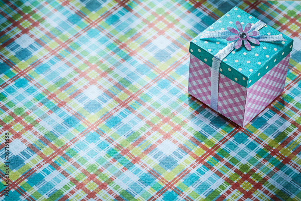 Packed present box on checked textile celebrations concept