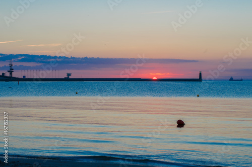 Sunrise with lighthouse on Baltic sea in Gdynia.