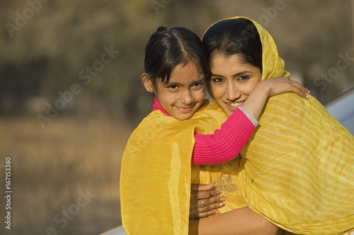 Billede på lærred Rural mother hugging her daughter