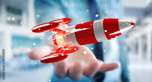 Businessman holding red rocket in his hand 3D rendering