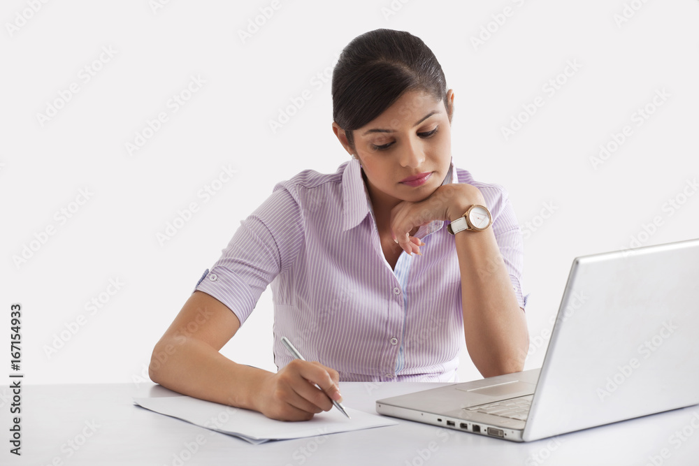 Young female executive taking down notes Young female executive taking down notes