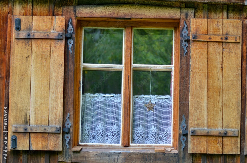 Old wooden window with metallic shutters. Lace curtains below. Vintage window from weekend house, Czech Republic. Old wooden window with metallic shutters. Lace curtains below. Vintage window from weekend house, Czech Republic.