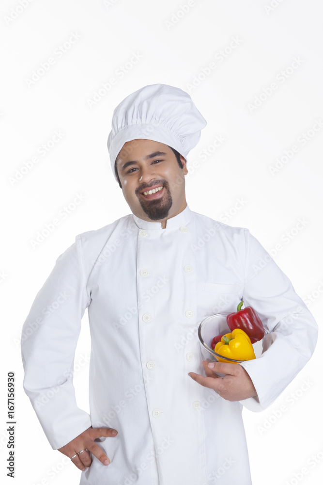 Portrait of chef with bowl of capsicum Portrait of chef with bowl of capsicum