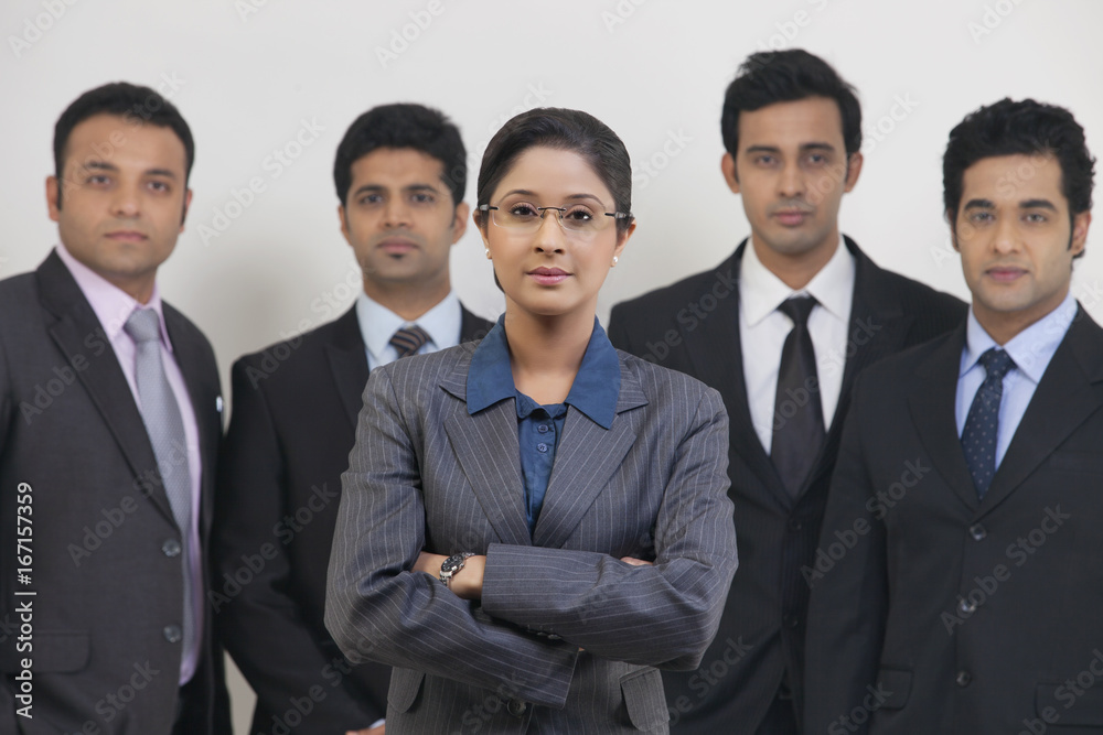 Group portrait of confident business people standing against gray background Group portrait of confident business people standing against gray background