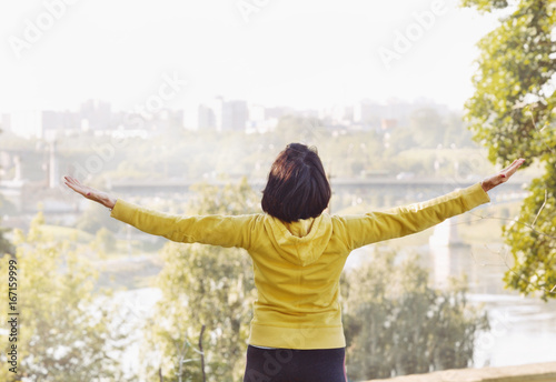 Joyful woman breathing fresh air outdoors