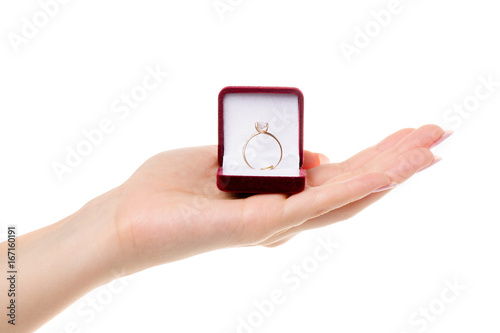 Gold ring in a box in a female hand