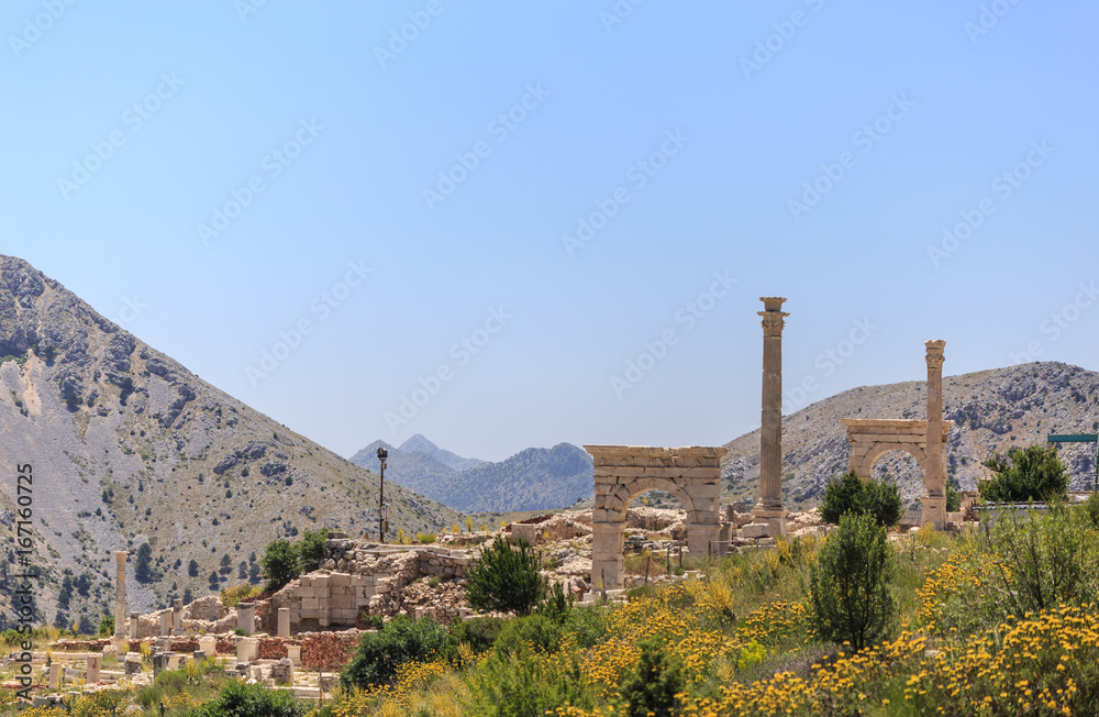Ancient city with arches and columns in mountains