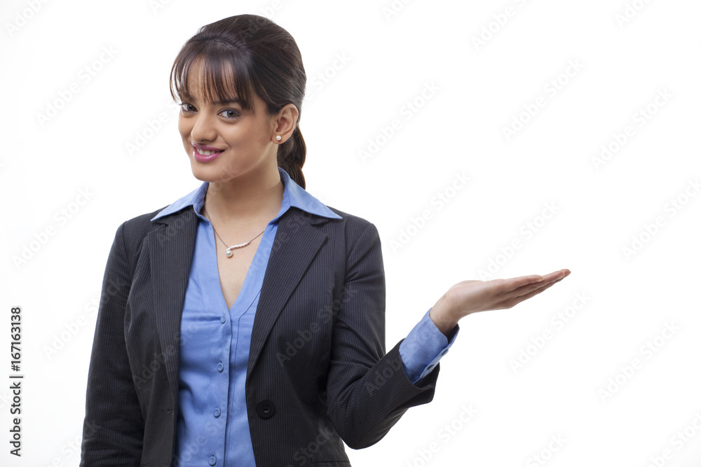 Portrait of confident young businesswoman presenting on white background Portrait of confident young businesswoman presenting on white background
