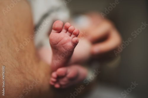 happy father with cute baby feets