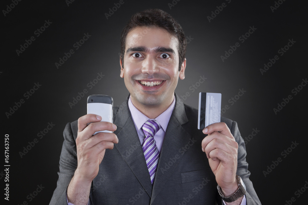 Portrait of businessman with mobile phone and credit card Portrait of businessman with mobile phone and credit card