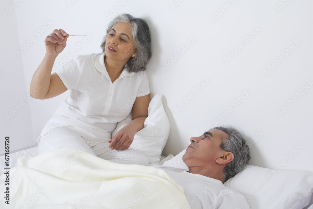 Wife checking husband's fever Wife checking husband's fever